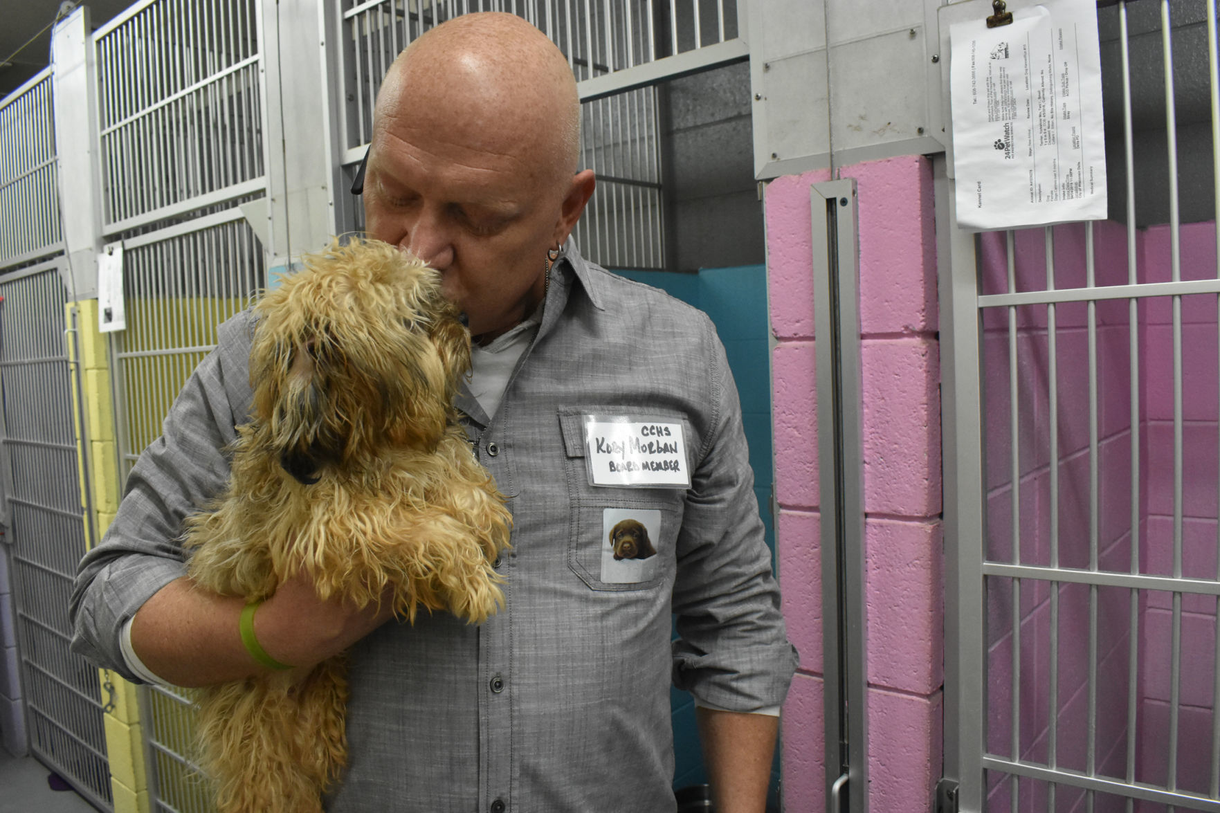 Kory Morgan kisses a terrier puppy